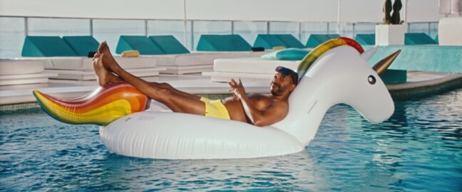 Man lounging on an inflatable unicorn