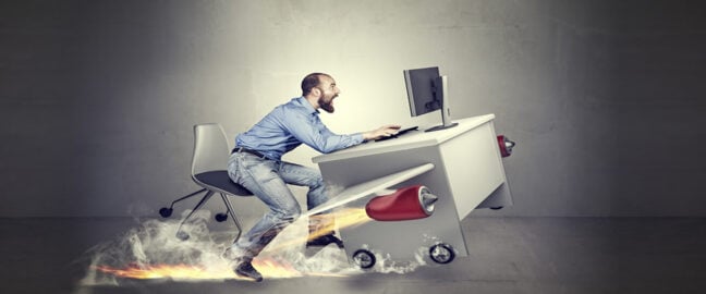 Man at a desk taking off