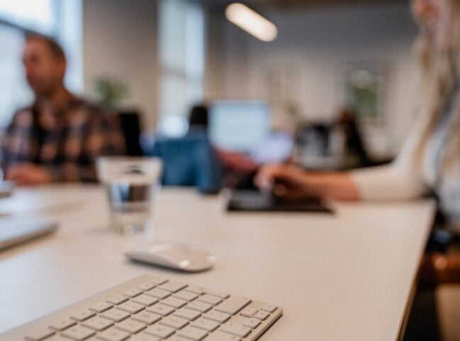AB Office keyboard focus with team in background