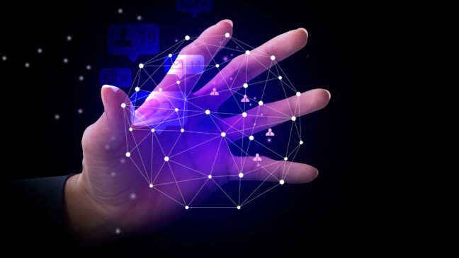 A hand reaching out, holding a matrix which represents the different elements of digital marketing